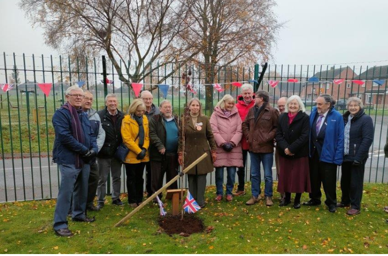 Claire Crackett DL, as link deputy lieutenant for Shawbury applied the final top dressing to a columnar cherry tree planted in the grounds of Shawbury Village Hall by Shawbury Gardening Club.
