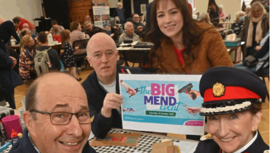 Simon Martin fixes a bowl for Vice Lord Lieutenant Jenny Wynn at The Big Mend. At the back from Veolia is Donald Macphail and Abby Simms